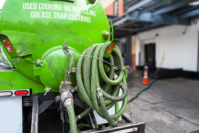 a service truck pumping grease from a restaurant's grease trap in Ash Fork AZ